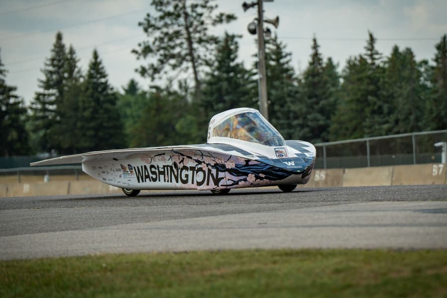 The Washington Solar Car team and their car during the 2026 race season