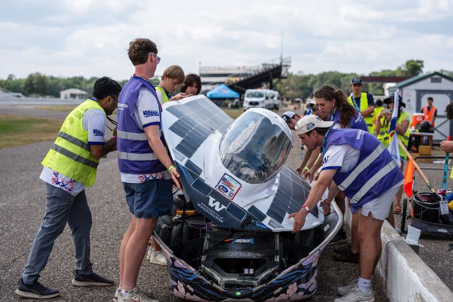 The Washington Solar Car team and their car during the 2026 race season