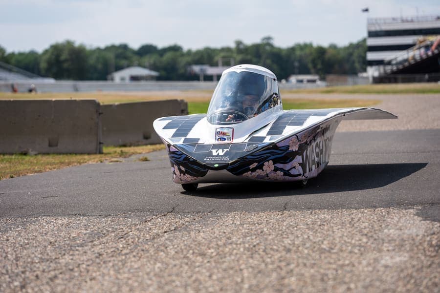 The Washington Solar Car team and their car during the 2026 race season