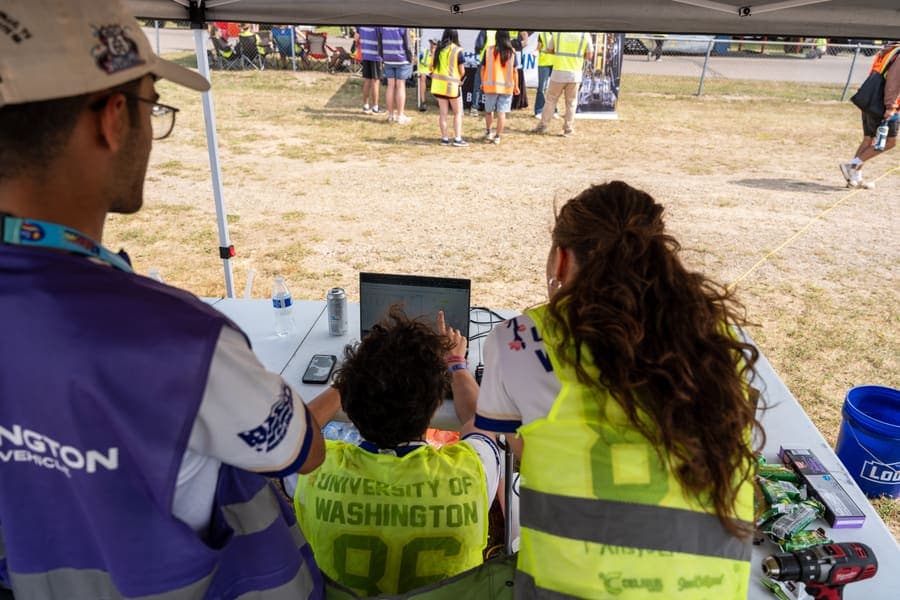 The Washington Solar Car team and their car during the 2026 race season