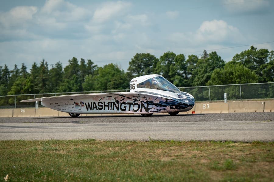 The Washington Solar Car team and their car during the 2026 race season