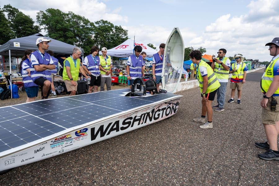 The Washington Solar Car team and their car during the 2026 race season