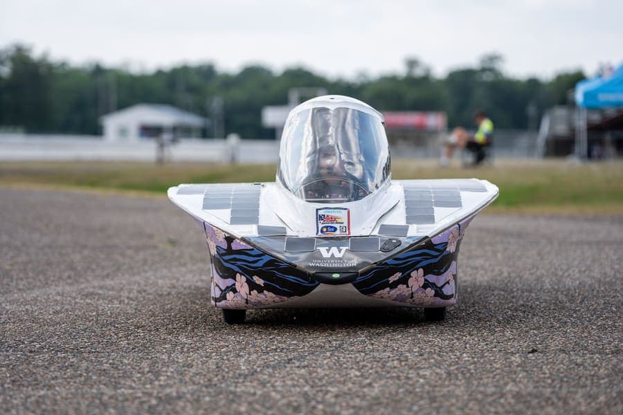 The Washington Solar Car team and their car during the 2026 race season