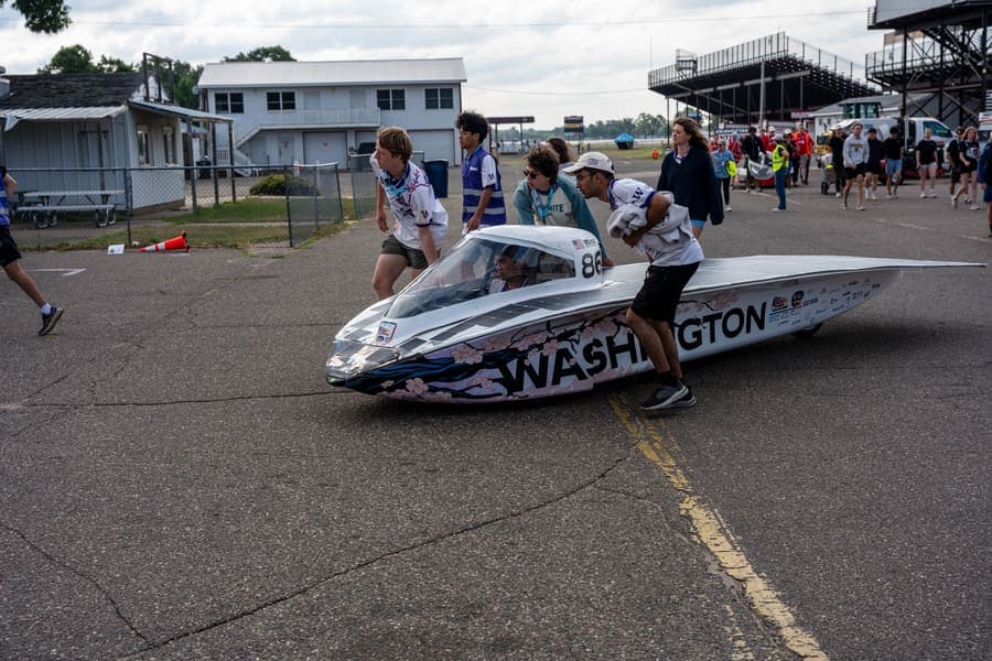 The Washington Solar Car team and their car during the 2026 race season