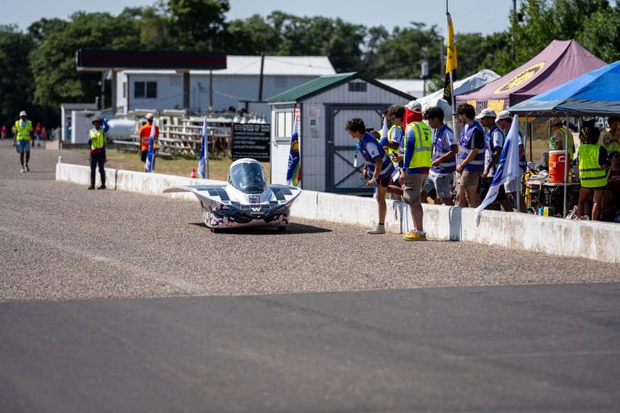 The Washington Solar Car team and their car during the 2026 race season