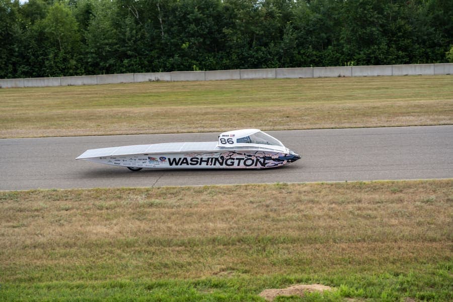 The Washington Solar Car team and their car during the 2026 race season
