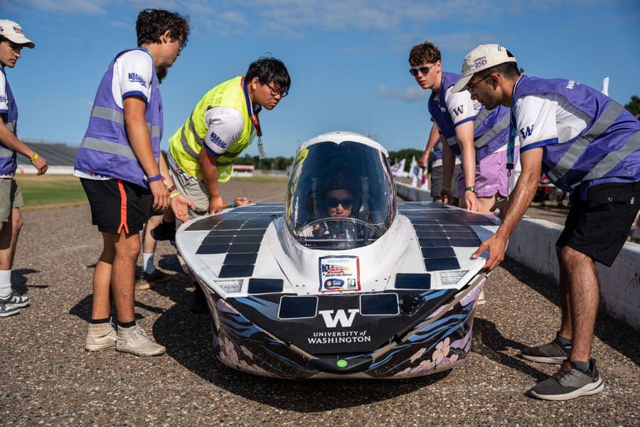 The Washington Solar Car team and their car during the 2026 race season