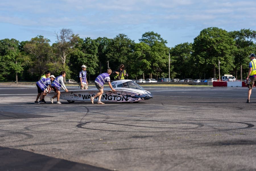 The Washington Solar Car team and their car during the 2026 race season