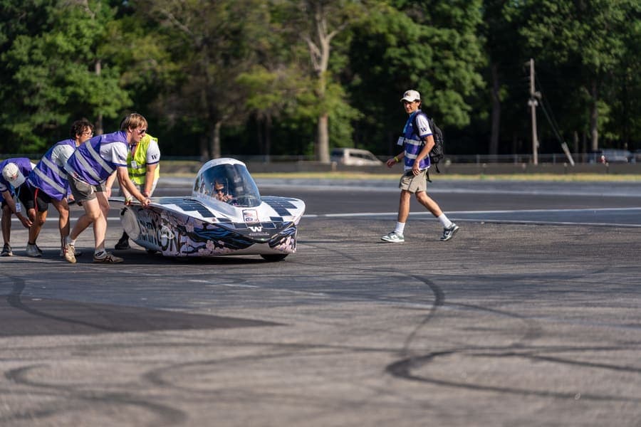 The Washington Solar Car team and their car during the 2026 race season