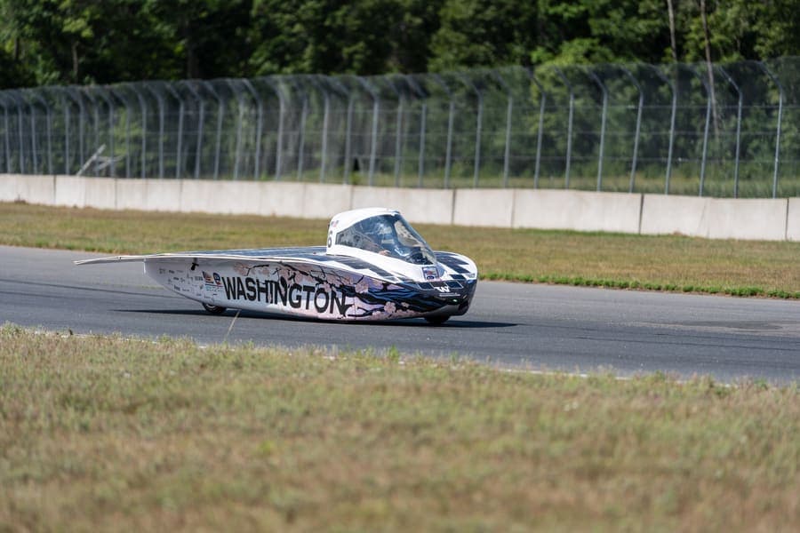 The Washington Solar Car team and their car during the 2026 race season