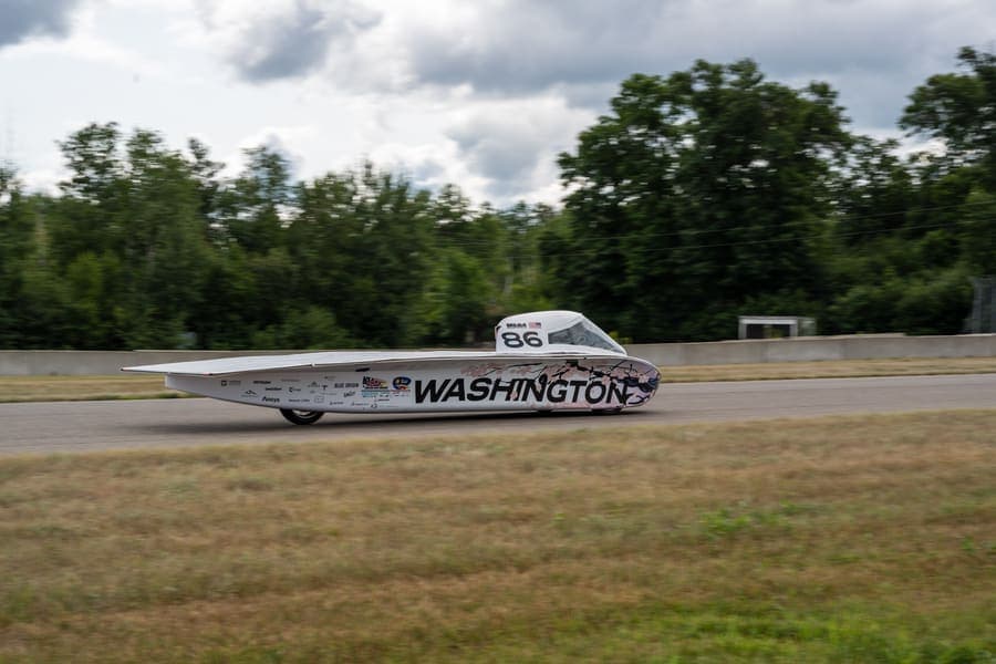 The Washington Solar Car team and their car during the 2026 race season