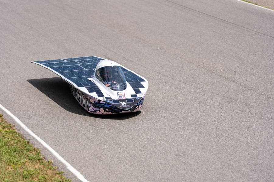 The Washington Solar Car team and their car during the 2026 race season