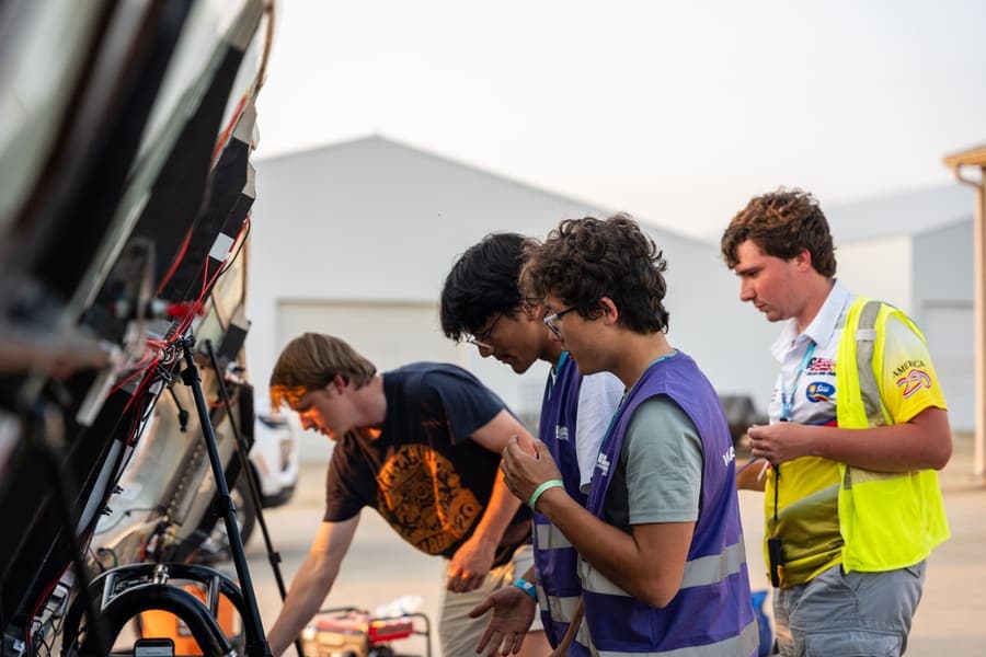 The Washington Solar Car team and their car during the 2026 race season
