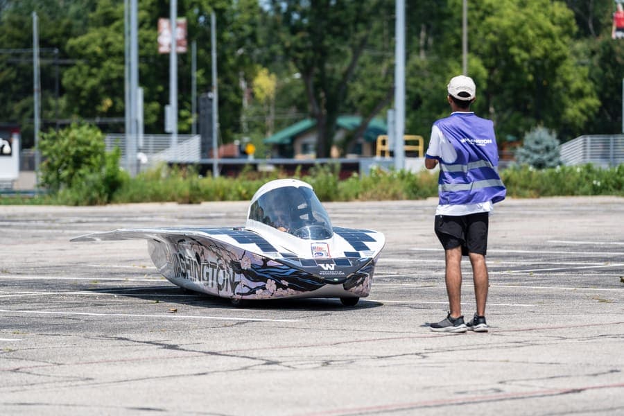 The Washington Solar Car team and their car during the 2026 race season