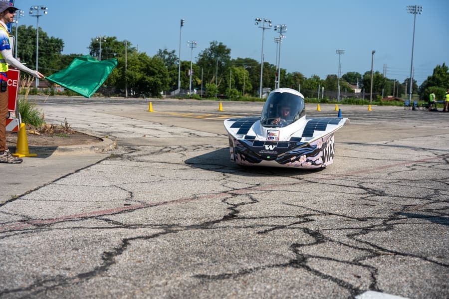 The Washington Solar Car team and their car during the 2026 race season