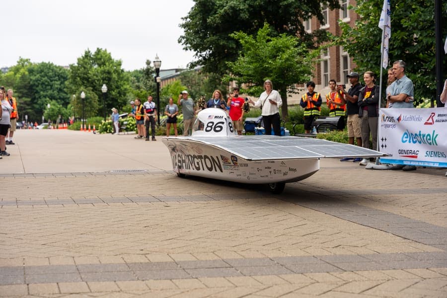 The Washington Solar Car team and their car during the 2026 race season