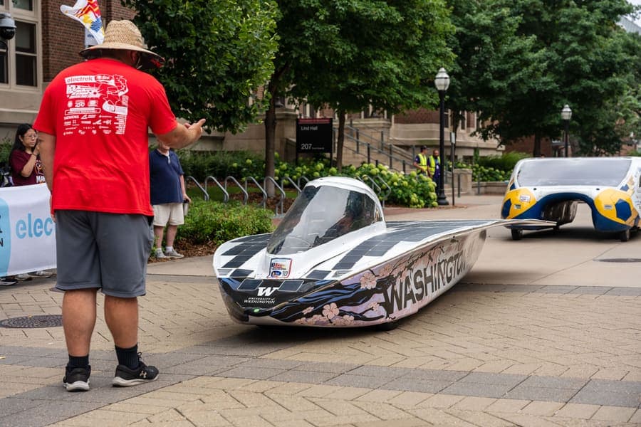 The Washington Solar Car team and their car during the 2026 race season