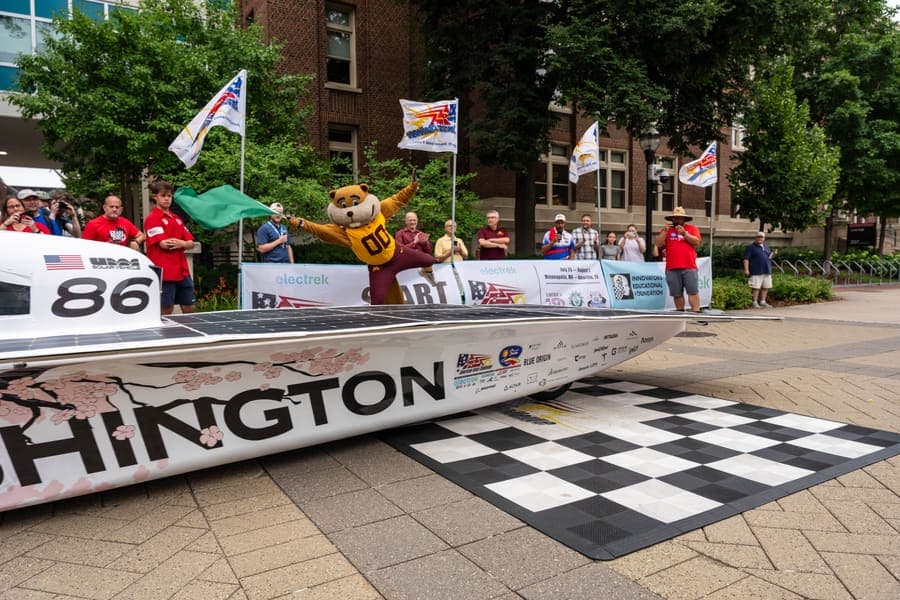 The Washington Solar Car team and their car during the 2026 race season