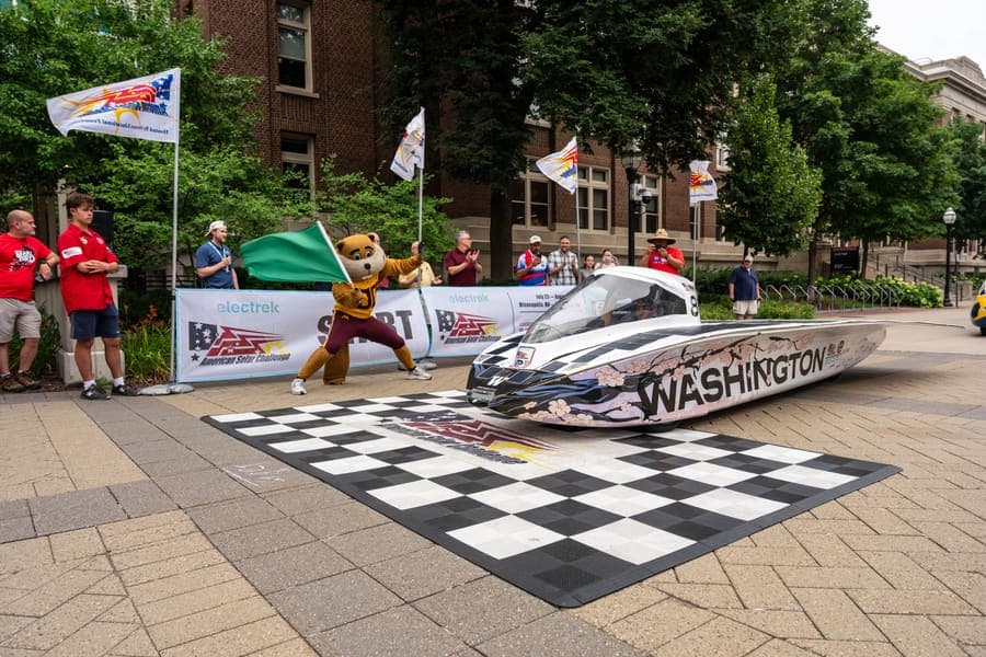 The Washington Solar Car team and their car during the 2026 race season