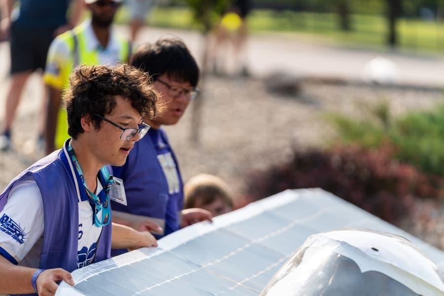 The Washington Solar Car team and their car during the 2026 race season