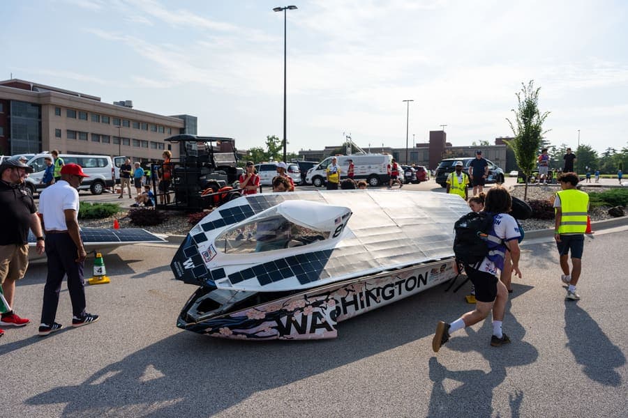 The Washington Solar Car team and their car during the 2026 race season
