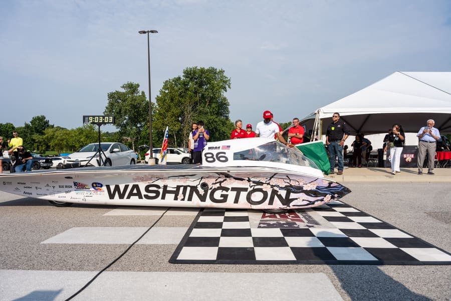 The Washington Solar Car team and their car during the 2026 race season