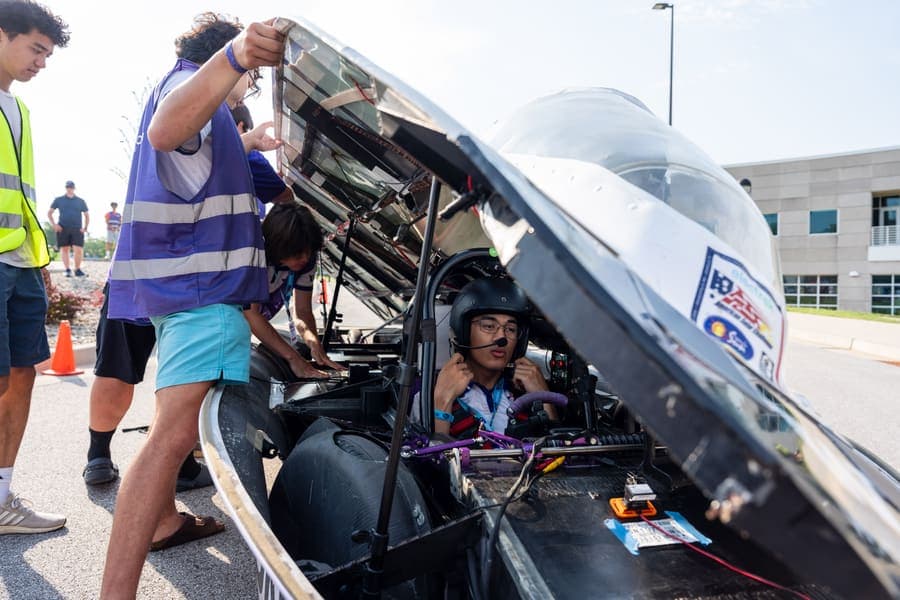 The Washington Solar Car team and their car during the 2026 race season