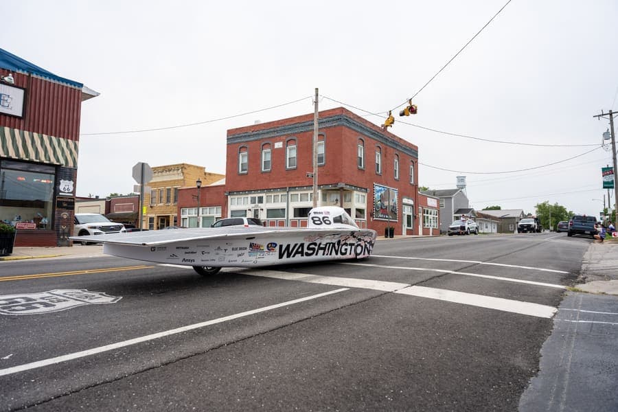 The Washington Solar Car team and their car during the 2026 race season
