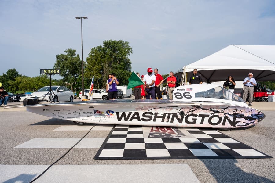 The Washington Solar Car team and their car during the 2026 race season