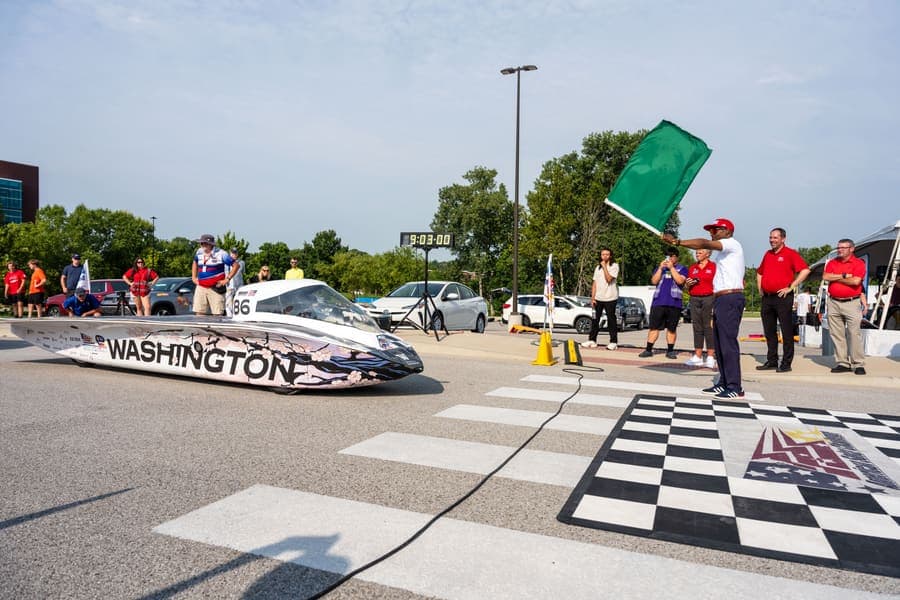 The Washington Solar Car team and their car during the 2026 race season