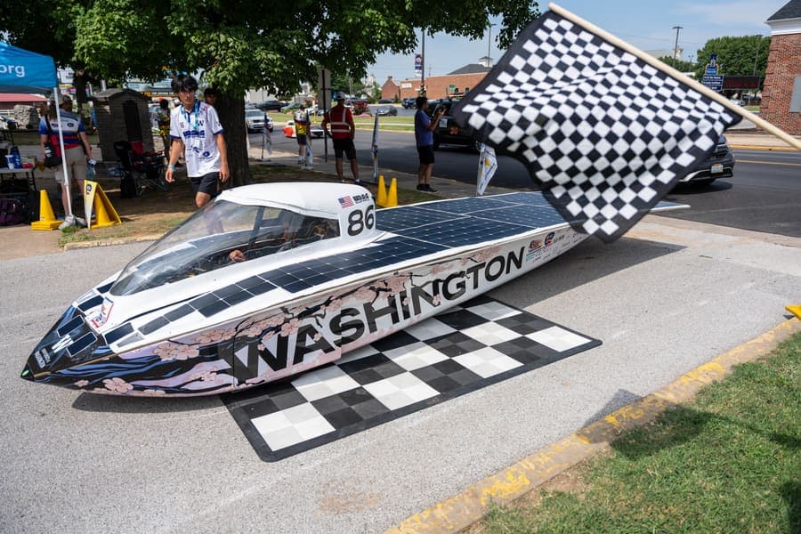 The Washington Solar Car team and their car during the 2026 race season