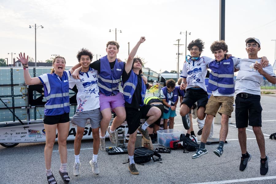 The Washington Solar Car team and their car during the 2026 race season