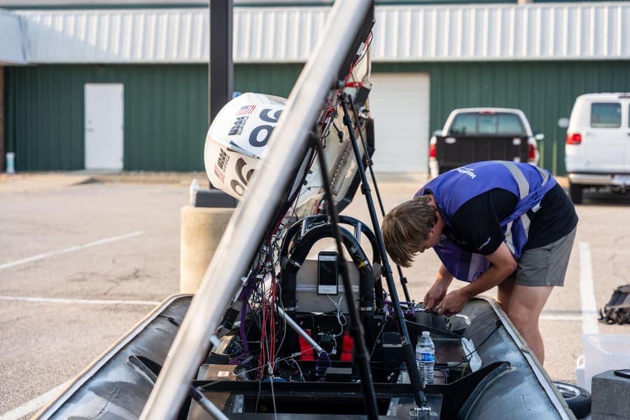 The Washington Solar Car team and their car during the 2026 race season