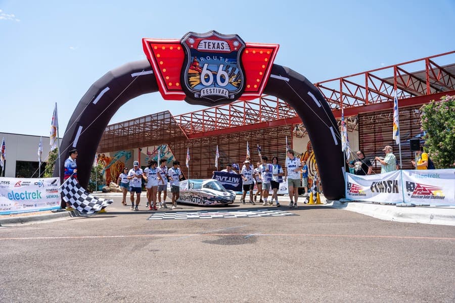 The Washington Solar Car team and their car during the 2026 race season