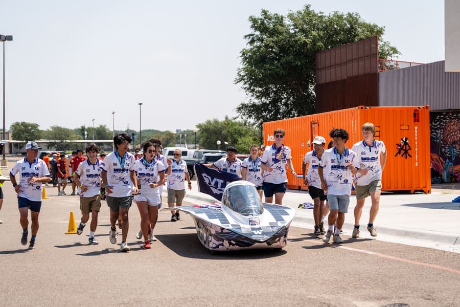 The Washington Solar Car team and their car during the 2026 race season