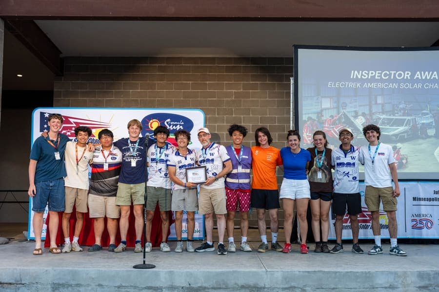 The Washington Solar Car team and their car during the 2026 race season